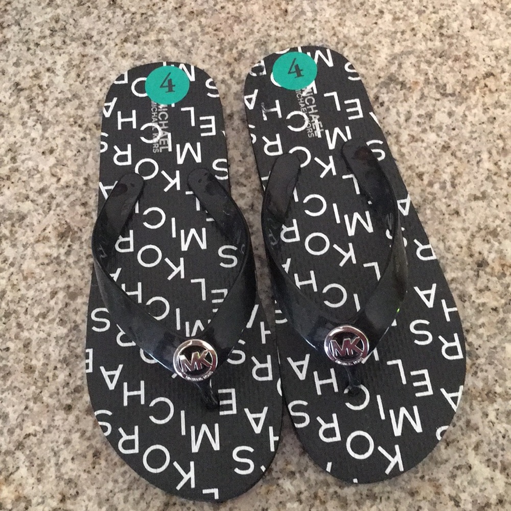 Michael Kor’s flip flops new